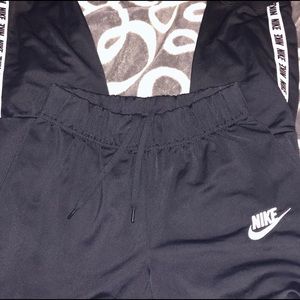 Nike kids black joggers with Nike logo on bottom.